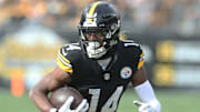 Nov 17, 2024; Pittsburgh, Pennsylvania, USA;  Pittsburgh Steelers wide receiver George Pickens (14) runs after a  catch against the Baltimore Ravens during the first quarter at Acrisure Stadium. Mandatory Credit: Charles LeClaire-Imagn Images
