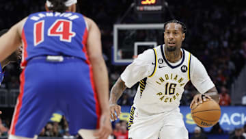 Mar 11, 2023; Detroit, Michigan, USA;  Indiana Pacers forward James Johnson (16) dribbles the ball against Detroit Pistons guard R.J. Hampton (14) in the second half at Little Caesars Arena. Mandatory Credit: Rick Osentoski-Imagn Images