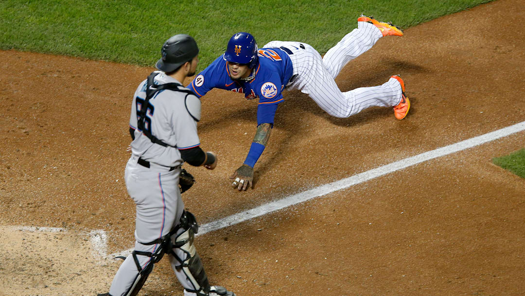 Javy Baez diving into the plate for the New York Mets