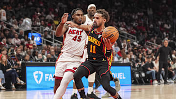 Atlanta Hawks guard Trae Young tries to get to the basket against Miami Heat guard Davion Mitchell.