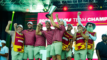 Sep 22, 2024; Carrolton, Texas, USA; Cameron Smith captain of Ripper GC holds LIV Golf Team Championship Trophy as he celebrates with teammates Marc Leishman, Matt Jones, Lucas Herbert and caddies during the LIV Golf Dallas Team Championship Finals at Maridoe Golf Club. Mandatory Credit: Jim Cowsert-Imagn Images