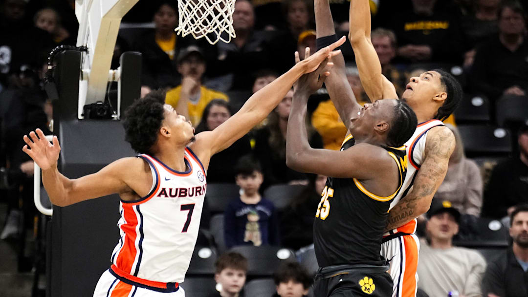 Jan 14, 2026; Columbia, Missouri, USA; Missouri Tigers guard Mark Mitchell (25) shoots as Auburn Tigers forward Keyshawn Hall (7) defends during the second half of the game at Mizzou Arena. Mandatory Credit: Denny Medley-Imagn Images