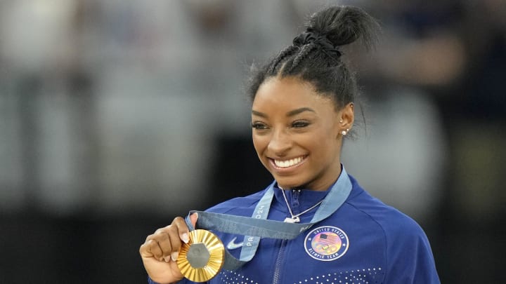 Aug 1, 2024; Paris, France; Simone Biles of the United States celebrates after winning the gold medal in the womenís gymnastics all-around during the Paris 2024 Olympic Summer Games at Bercy Arena. Mandatory Credit: Kyle Terada-USA TODAY Sports