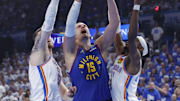 May 13, 2025; Oklahoma City, Oklahoma, USA; Denver Nuggets center Nikola Jokic (15) goes up for a basket between Oklahoma City Thunder center Isaiah Hartenstein (55) and guard Shai Gilgeous-Alexander (2) during the first quarter of game five of the second round for the 2025 NBA Playoffs at Paycom Center. Mandatory Credit: Alonzo Adams-Imagn Images