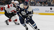 Dec 19, 2024; Columbus, Ohio, USA; Columbus Blue Jackets defenseman Ivan Provorov (9) carries the puck as New Jersey Devils right wing Timo Meier (28) trails the play during the third period at Nationwide Arena. Mandatory Credit: Russell LaBounty-Imagn Images