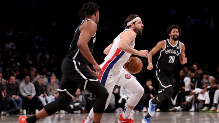 Dec 23, 2023; Brooklyn, New York, USA; Detroit Pistons forward Joe Harris (31) brings the ball up court against Brooklyn Nets guards Dennis Smith Jr. (4)  and Spencer Dinwiddie (26) during the third quarter at Barclays Center. Mandatory Credit: Brad Penner-USA TODAY Sports