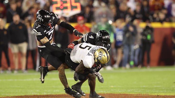 Oct 19, 2024; Ames, Iowa, USA; UCF Knights tight end Randy Pittman Jr. (5) is tackled by Iowa State Cyclones defensive back Jeremiah Cooper (4) at Jack Trice Stadium. Mandatory Credit: Reese Strickland-Imagn Images