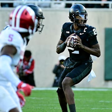 Nov 2, 2024; East Lansing, Michigan, USA;  Michigan State Spartans quarterback Aidan Chiles (2) looks for an open receiver during the third quarter against the Indiana Hoosiers at Spartan Stadium. Mandatory Credit: Dale Young-Imagn Images