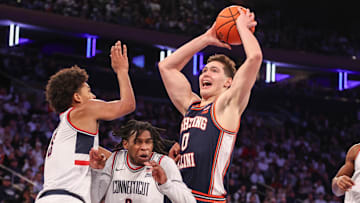 Nov 28, 2025; New York, New York, USA;  Illinois Fighting Illini forward David Mirkovic (0) collides with UConn Huskies guard Malachi Smith (0) in the second half at Madison Square Garden. Mandatory Credit: Wendell Cruz-Imagn Images