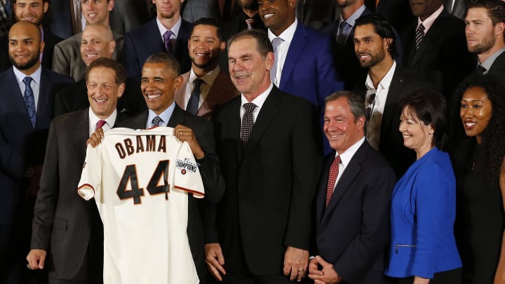 Jun 4, 2015; Washington, DC, USA; President Barack Obama (center) poses with San Francisco Giants team president Larry Baer (left), manager Bruce Bochy (right), and members of the Giants during a ceremony honoring the World Series champion Giants in the East Room at the White House. Mandatory Credit: Geoff Burke-USA TODAY Sports