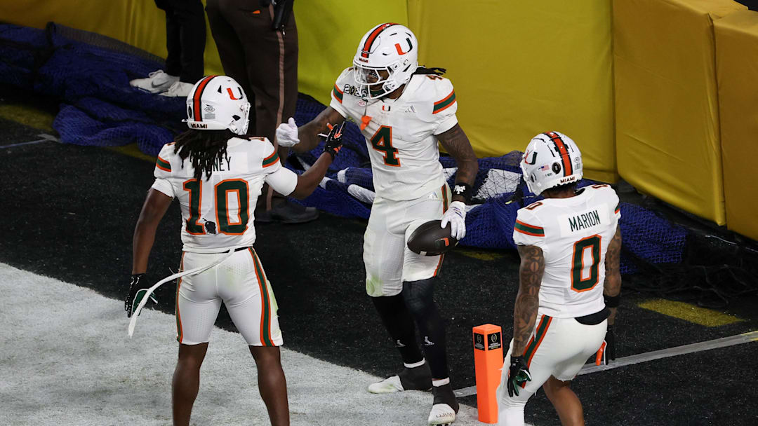 Jan 19, 2026; Miami Gardens, FL, USA; Miami Hurricanes running back Mark Fletcher Jr. (4) celebrates with wide receiver Malachi Toney (10) and wide receiver Keelan Marion (0) after scoring a touchdown against the Indiana Hoosiers in the third quarter during the College Football Playoff National Championship game at Hard Rock Stadium. Mandatory Credit: Kim Klement Neitzel-Imagn Images