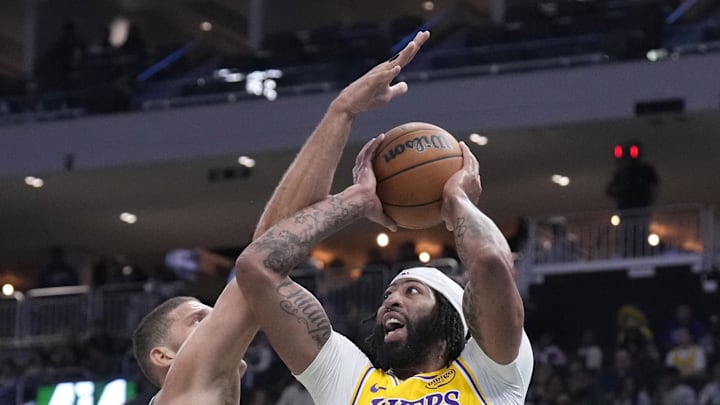Oct 10, 2024; Milwaukee, Wisconsin, USA; Los Angeles Lakers forward Anthony Davis (3) shoots against Milwaukee Bucks Milwaukee Bucks center Brook Lopez (11) in the first half at Fiserv Forum. Mandatory Credit: Michael McLoone-Imagn Images
