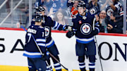 Sep 25, 2024; Winnipeg, Manitoba, CAN; Winnipeg Jets forward Brad Lambert (93) is congratulated by his teammates on his goal against the Edmonton Oilers during the third  period at Canada Life Centre. Mandatory Credit: Terrence Lee-Imagn Images