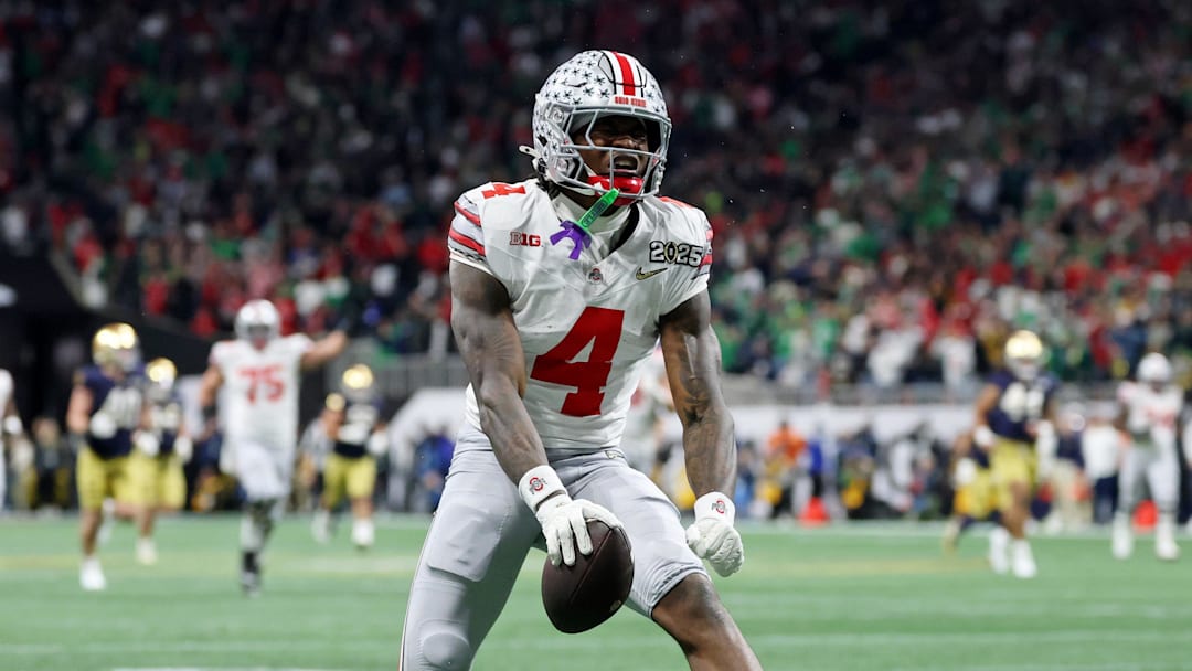 Jan 20, 2025; Atlanta, GA, USA; Ohio State Buckeyes wide receiver Jeremiah Smith (4) reacts after making a catch against the Notre Dame Fighting Irish during the second half the CFP National Championship college football game at Mercedes-Benz Stadium. Mandatory Credit: Mark J. Rebilas-Imagn Images