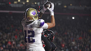 Sep 27, 2024; Piscataway, New Jersey, USA; Washington Huskies wide receiver Denzel Boston (12) catches the ball a touchdown pass during the second half against Rutgers Scarlet Knights defensive back Robert Longerbeam (7) at SHI Stadium. Mandatory Credit: Vincent Carchietta-Imagn Images