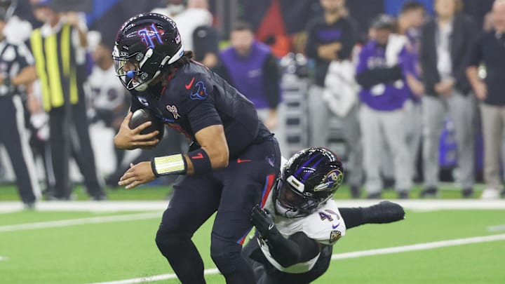 Dec 25, 2024; Houston, Texas, USA;Houston Texans quarterback C.J. Stroud (7) is sacked by Baltimore Ravens linebacker Chris Board (49)  in the second half at NRG Stadium. Mandatory Credit: Thomas Shea-Imagn Images