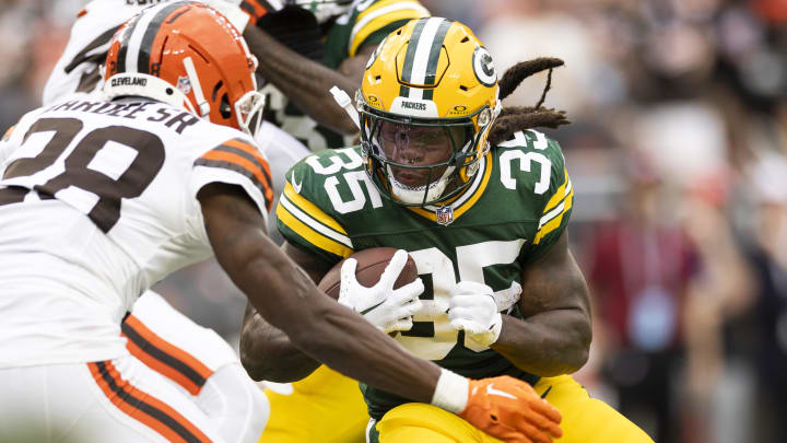 Aug 10, 2024; Cleveland, Ohio, USA; Green Bay Packers running back Jarveon Howard (35) runs the ball as Cleveland Browns cornerback Justin Hardee Sr. (28) tackles him during the fourth quarter at Cleveland Browns Stadium. Mandatory Credit: Scott Galvin-USA TODAY Sports