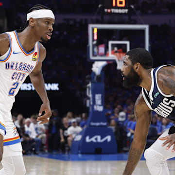May 7, 2024; Oklahoma City, Oklahoma, USA; Oklahoma City Thunder guard Shai Gilgeous-Alexander (2) works his way to the basket against Dallas Mavericks guard Kyrie Irving (11) during the second quarter of game one of the second round for the 2024 NBA playoffs at Paycom Center. Mandatory Credit: Alonzo Adams-Imagn Images