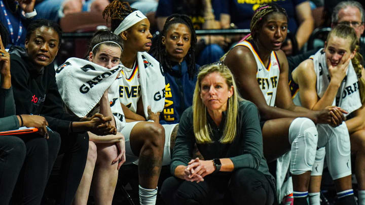 Jun 10, 2024; Uncasville, Connecticut, USA; Indiana Fever guard Caitlin Clark (22) on the bench with her teammates in the second half as they take on the Connecticut Sun at Mohegan Sun Arena. Mandatory Credit: David Butler II-USA TODAY Sports