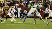 Nov 2, 2025; Landover, Maryland, USA;  Seattle Seahawks wide receiver Jaxon Smith-Njigba (11) runs with ball after making a catch defended by Washington Commanders linebacker Frankie Luvu (4) during the first quarter at Northwest Stadium. Mandatory Credit: Geoff Burke-Imagn Images