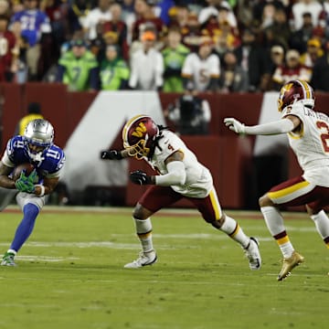 Nov 2, 2025; Landover, Maryland, USA;  Seattle Seahawks wide receiver Jaxon Smith-Njigba (11) runs with ball after making a catch defended by Washington Commanders linebacker Frankie Luvu (4) during the first quarter at Northwest Stadium. Mandatory Credit: Geoff Burke-Imagn Images