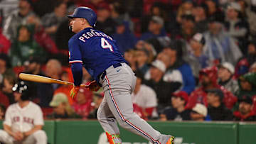 Texas Rangers designated hitter Joc Pederson (4) hits a ground rule double to drive in a run against the Boston Red Sox