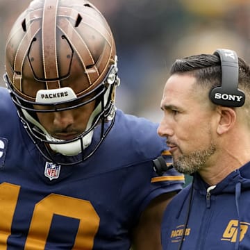 Green Bay Packers coach Matt LaFleur talks to quarterback Jordan Love during the second half against the Carolina Panthers.