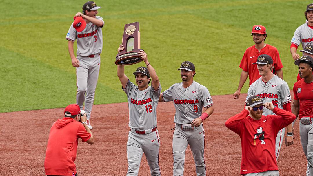 Jun 7, 2026; Athens, GA, USA; Georgia Bulldogs pitcher Caden Aoki (12) carries the Super Regional championship trophy after Georgia defeated the Mississippi State Bulldogs at Foley Field. Mandatory Credit: Dale Zanine-Imagn Images