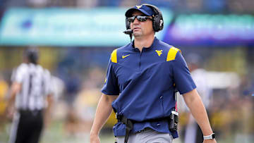 Sep 21, 2024; Morgantown, West Virginia, USA; West Virginia Mountaineers head coach Neal Brown walks along the sidelines during the second quarter against the Kansas Jayhawks at Mountaineer Field at Milan Puskar Stadium. Mandatory Credit: Ben Queen-Imagn Images