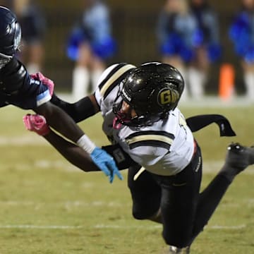 Dorman running back Nick Means (1) breaks the tackle of Gaffney Ayden Montgomery (14) Friday, Oct. 24, 2025, during the SCHSL football game at Dorman High School in Roebuck, South Carolina.