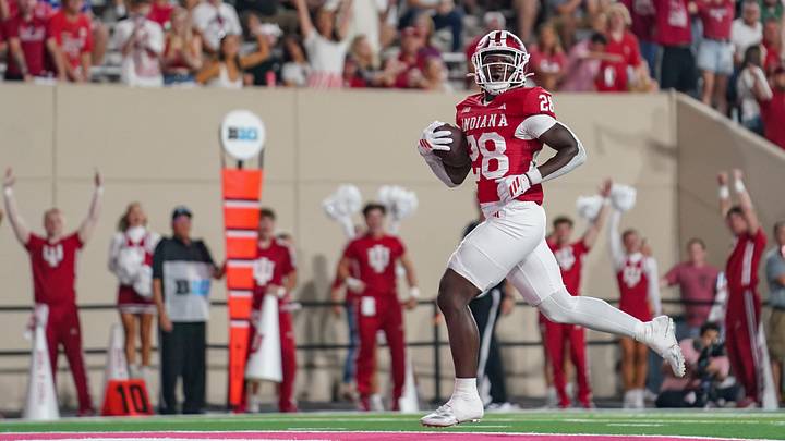 Sep 12, 2025; Bloomington, Indiana, USA; Indiana Hoosiers running back Khobie Martin (28) runs for a touchdown during the second half against the Indiana State Sycamores at Memorial Stadium. Mandatory Credit: Robert Goddin-Imagn Images