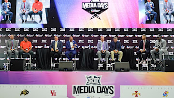 Head coaches Willie Fritz of Houston, Mike Gundy of Oklahoma State, Rich Rodriguez of West Virginia, Lance Leipold of Kansas, Sonny Dykes of TCU, Kyle Whittingham of Utah, Brent Brennan of Arizona and Deion Sanders of Colorado all sit on stage for a Coaches Roundtable during 2025 Big 12 Football Media Days at The Star.