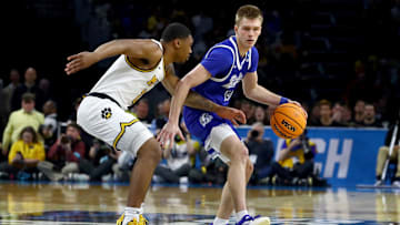 Mar 20, 2025; Wichita, KS, USA; Drake Bulldogs guard Bennett Stirtz (14) dribbles against Missouri Tigers guard Tony Perkins (12) in the first half of a first round men’s NCAA Tournament game at Intrust Bank Arena. Mandatory Credit: Nick Tre. Smith-Imagn Images
