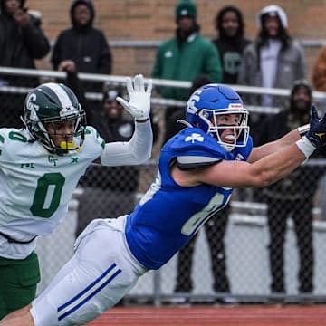 Novi Detroit Catholic Central's Jack Janda stretches out but fails to pull in the pass while covered by Detroit Cass Tech's Lamont Wilcoxson in the fourth quarter during the MHSAA Division 1 semifinals at Troy Athens High School on Saturday, Nov. 23, 2024.