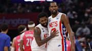 Dec 12, 2022; Washington, District of Columbia, USA; Brooklyn Nets guard Kyrie Irving (11) celebrates with Nets forward Kevin Durant (7) against the Washington Wizards in the fourth quarter at Capital One Arena. Mandatory Credit: Geoff Burke-Imagn Images