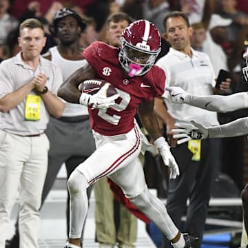 Sep 28, 2024; Tuscaloosa, Alabama, USA;  Alabama Crimson Tide wide receiver Ryan Williams (2) breaks a tackle by Georgia Bulldogs defensive back KJ Bolden (4) to score a touchdown that put Alabama ahead in the fourth quarter at Bryant-Denny Stadium. Alabama defeated Georgia 41-34. Mandatory Credit: Gary Cosby Jr.-Imagn Images