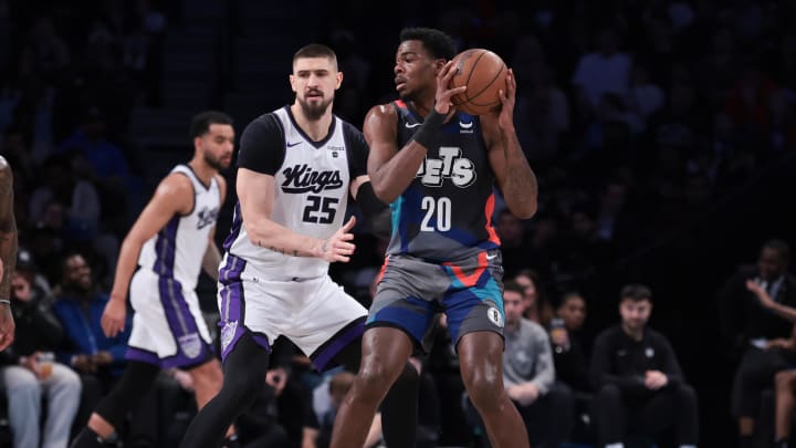Apr 7, 2024; Brooklyn, New York, USA; Brooklyn Nets center Day'Ron Sharpe (20) looks to pass as Sacramento Kings center Alex Len (25) defends during the first half at Barclays Center. Mandatory Credit: Vincent Carchietta-USA TODAY Sports