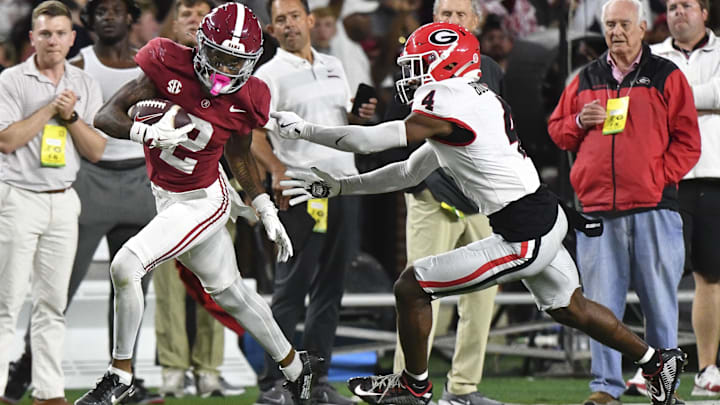 Sep 28, 2024; Tuscaloosa, Alabama, USA;  Alabama Crimson Tide wide receiver Ryan Williams (2) breaks a tackle by Georgia Bulldogs defensive back KJ Bolden (4) to score a touchdown that put Alabama ahead in the fourth quarter at Bryant-Denny Stadium. Alabama defeated Georgia 41-34. Mandatory Credit: Gary Cosby Jr.-Imagn Images