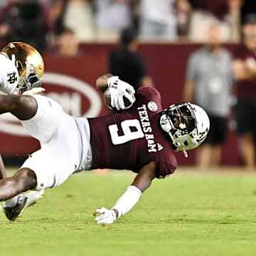 Aug 31, 2024; College Station, Texas, USA; Notre Dame Fighting Irish cornerback Christian Gray (29) tackles Texas A&M Aggies defensive back Trey Jones III (9) in the fourth quarter at Kyle Field. 