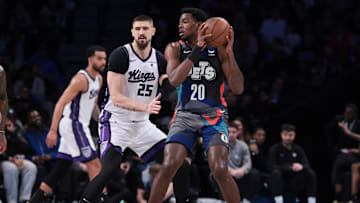 Apr 7, 2024; Brooklyn, New York, USA; Brooklyn Nets center Day'Ron Sharpe (20) looks to pass as Sacramento Kings center Alex Len (25) defends during the first half at Barclays Center. Mandatory Credit: Vincent Carchietta-Imagn Images