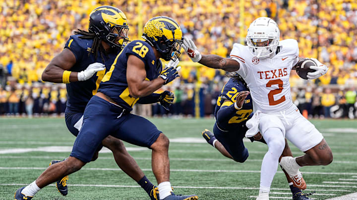 Texas wide receiver Matthew Golden (2) is stopped by Michigan defensive back Jyaire Hill (20), defensive back Quinten Johnson (28) during the first half at Michigan Stadium in Ann Arbor on Saturday, September 7, 2024.