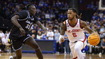 Jan 18, 2025; Newark, New Jersey, USA; St. John's basketball guard Deivon Smith (5) goes to the basket asSeton Hall Pirates guard Garwey Dual (33) defends during the first half at Prudential Center. 
