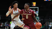 Jan 8, 2025; Coral Gables, Florida, USA; Florida State Seminoles guard Chandler Jackson (0) drives to the basket past Miami Hurricanes guard Jalil Bethea (3) during the first half at Watsco Center. Mandatory Credit: Sam Navarro-Imagn Images