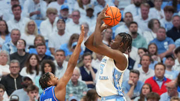 Nov 7, 2025; Chapel Hill, North Carolina, USA;  North Carolina Tar Heels forward Caleb Wilson (8) shoots as Kansas Jayhawks guard Elmarko Jackson (13) defends in the first half at Dean E. Smith Center. Mandatory Credit: Bob Donnan-Imagn Images