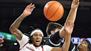 Arkansas Razorbacks guard Boogie Fland (2) and Little Rock Trojans guard Isaiah Lewis (3) reach for a rebound in the first half at Bud Walton Arena.