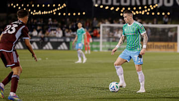 Apr 26, 2025; Commerce City, Colorado, USA; Seattle Sounders forward Ryan Kent (77) controls the ball as Colorado Rapids midfielder Cole Bassett (23) defends in the second half at Dick's Sporting Goods Park. Mandatory Credit: Isaiah J. Downing-Imagn Images
