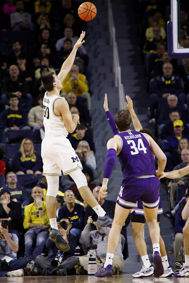 Jan 19, 2025; Ann Arbor, Michigan, USA;  Michigan's Vladislav Goldin shoots over Northwestern's Matthew Nicholson.