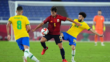 Aug 7, 2021; Yokohama, Japan; Team Spain midfielder Martin Zubimendi (6) tries to control the ball against Team Brazil midfielder Claudinho (20) in extra time following the second half of the gold medal match in the Tokyo 2020 Olympic Summer Games at Nissan Stadium. Mandatory Credit: Kareem Elgazzar-Imagn Images