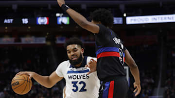 Jan 17, 2024; Detroit, Michigan, USA;  Minnesota Timberwolves center Karl-Anthony Towns (32) dribbles defended by Detroit Pistons forward Ausar Thompson (9): Rick Osentoski-Imagn Images