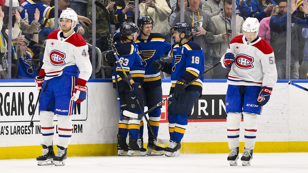 Mar 25, 2025; St. Louis, Missouri, USA;  St. Louis Blues defenseman Philip Broberg (6) is congratulated by left wing Jake Neighbours (63) and center Robert Thomas (18) after scoring against the Montreal Canadiens during the third period at Enterprise Center. Mandatory Credit: Jeff Curry-Imagn Images